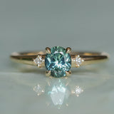 0.90ct Oval Light Blue Green Montana Sapphire and Princess Cut Diamond Rapids Low Profile Ring in 14k Yellow Gold