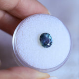 1.73CT PRECISION CUT OVAL MONTANA SAPPHIRE, DENIM PARTI TEAL WITH EARTHY INCLUSIONS, 7.47X6.16X4.69MM