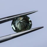 2.57CT FANCY PRECISION CUSHION MONTANA SAPPHIRE, PARTI OLIVE GREEN AND GOLD, 8.82X7.54X5.37MM - APPRAISED STONE