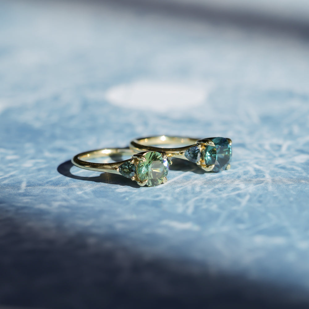 1.82ct Round Teal Precision Cut Montana Sapphire and Trillion Sapphire Low Profile Three Stone Ring in 18k Yellow Gold