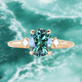 1.98ct Oval Precision Cut Teal Montana Sapphire and Princess Cut Diamond Rapids Low Profile Ring in 14k Yellow Gold