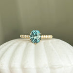 1.94ct Precision Cut Teal Oval Montana Sapphire Lotus Six Prong Solitaire with Diamonds in 14k Yellow Gold