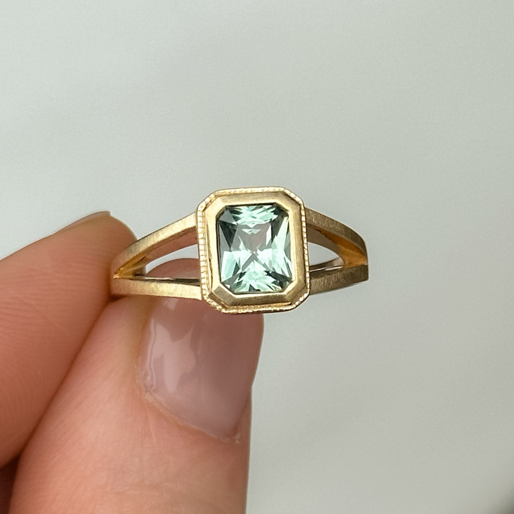 1.20ct Radiant Cut Seafoam Montana Sapphire Split Shank Bezel Ring with Milgrain in 14k Yellow Gold