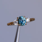 1.36ct Oval Montana Sapphire and Lab Diamond Three Stone Ring in 14K Yellow Gold with Evergreen Texture